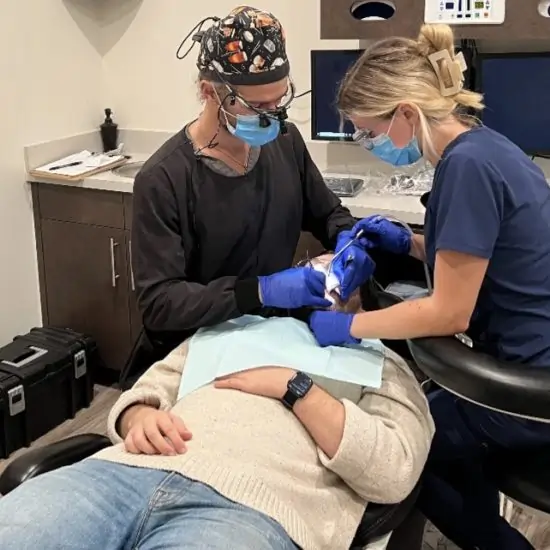 Dr. Brazil performing wisdom teeth extractions